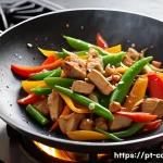 중식조리 이론에서 자주 틀리는 문제 - A vibrant, high-angle close-up of a traditional Chinese stir-fry in a well-seasoned wok on a gas sto...